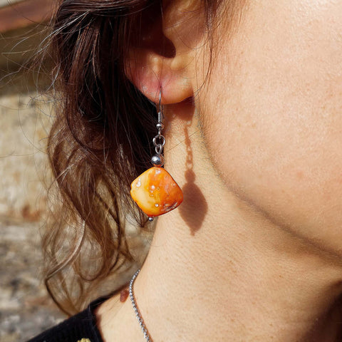 Handmade orange mother of pearl dangle drop earrings with stainless steel and hypoallergenic hooks.