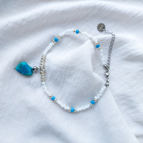 Handmade mother of pearl beaded anklet. With a blue mother of pearl pendant and acrylic beads, nylon thread and stainless steal beads and hook.